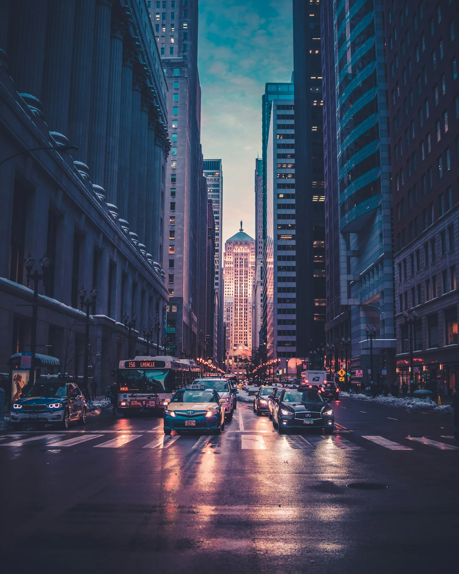 Dusk metropolitan canyon with glowing traffic and architectural depth